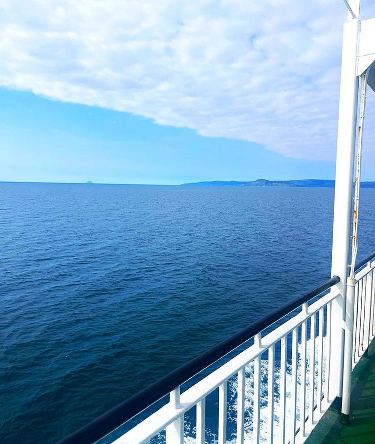 Passengers on the open-air ferry deck during the crossing to Arran