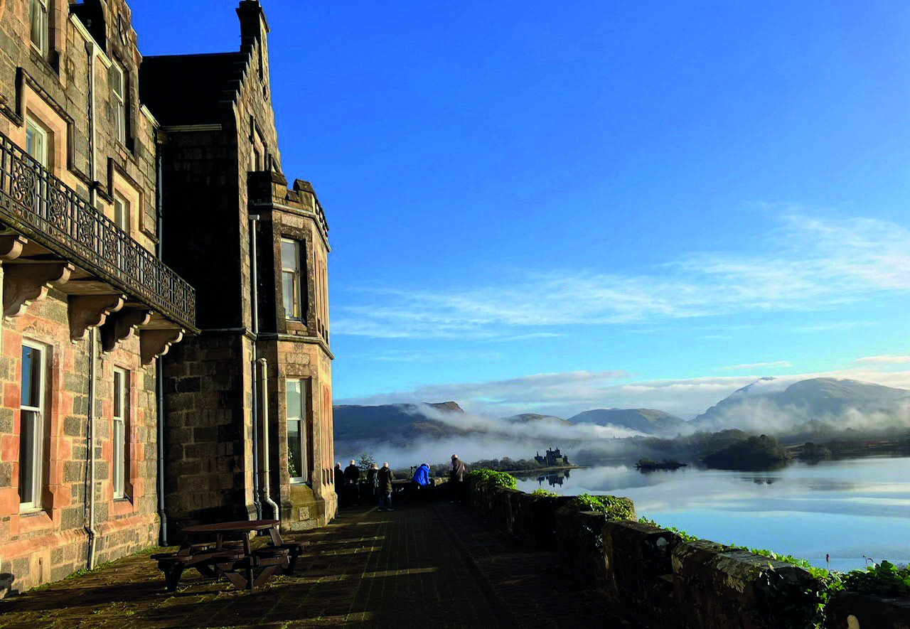 View of Loch Awe from the side of the Loch Awe Hotel, showcasing tranquil waters and surrounding lush green hills.