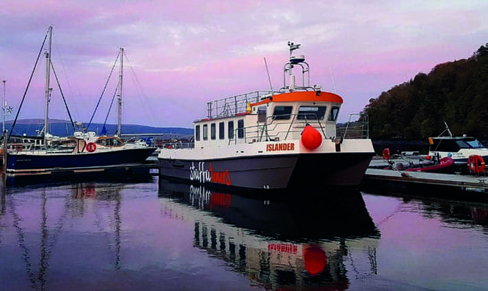 Passengers on a Staffa sealife cruise, enjoying views of marine wildlife and the scenic coastal landscape.