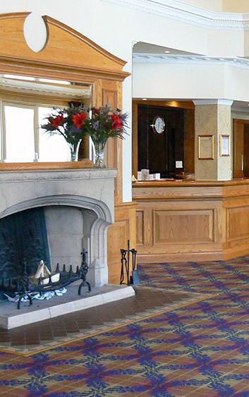 Loch Tummel Hotel's stunning entrance with traditional Scottish architecture and mountain views