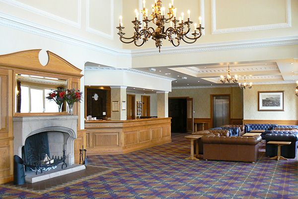 Loch Tummel Hotel's stunning entrance with traditional Scottish architecture and mountain views